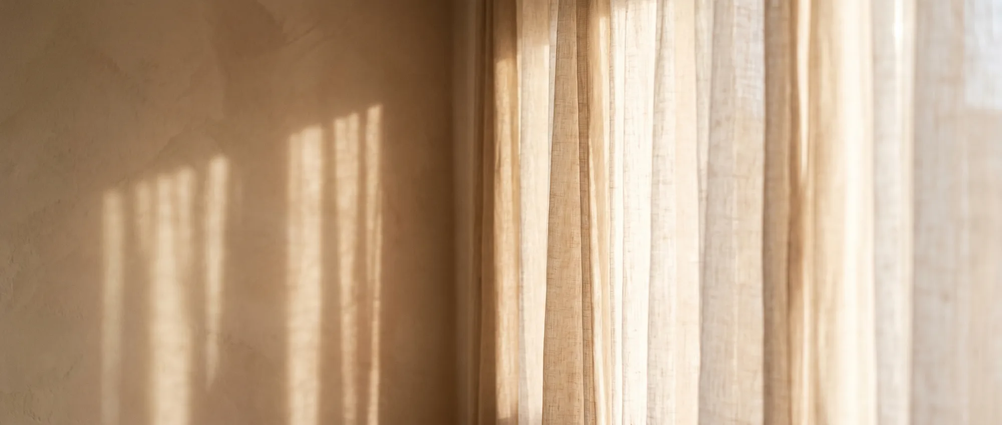 Soft golden morning light through sheer linen curtains
